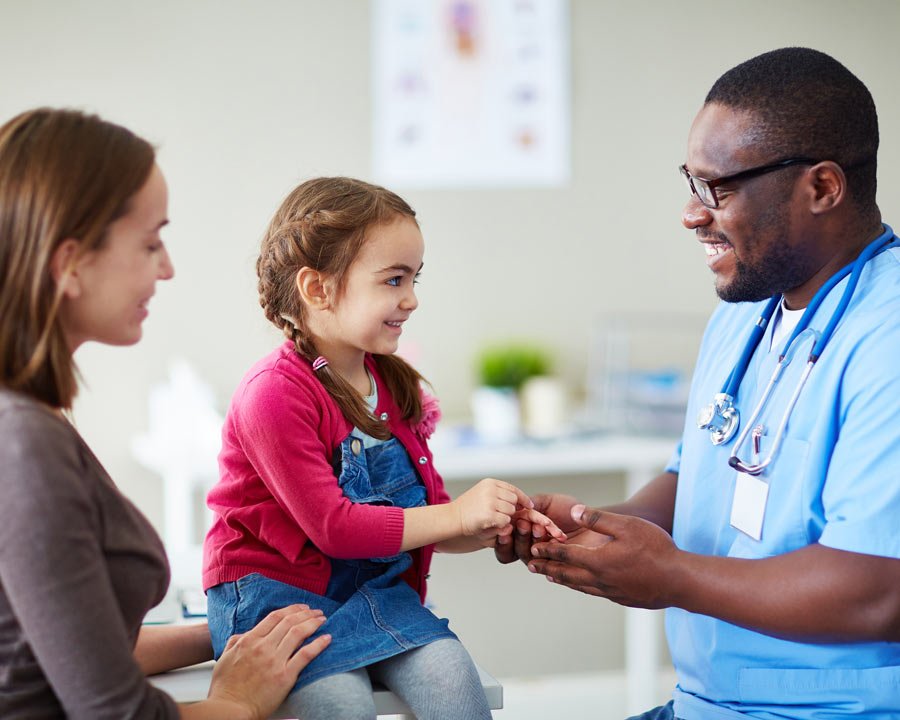 Doctor with child patient and her mother