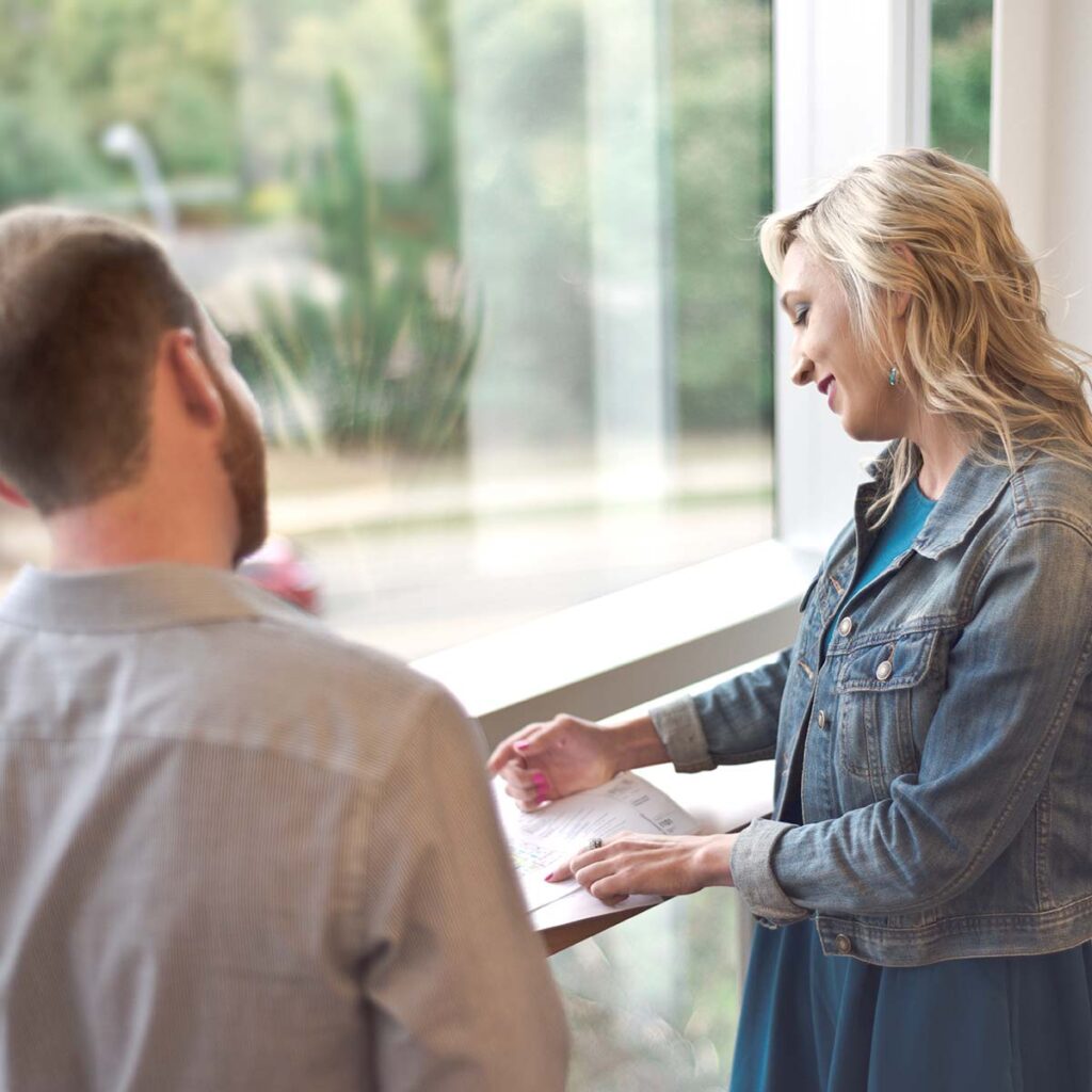 ERDMAN employees talking by window