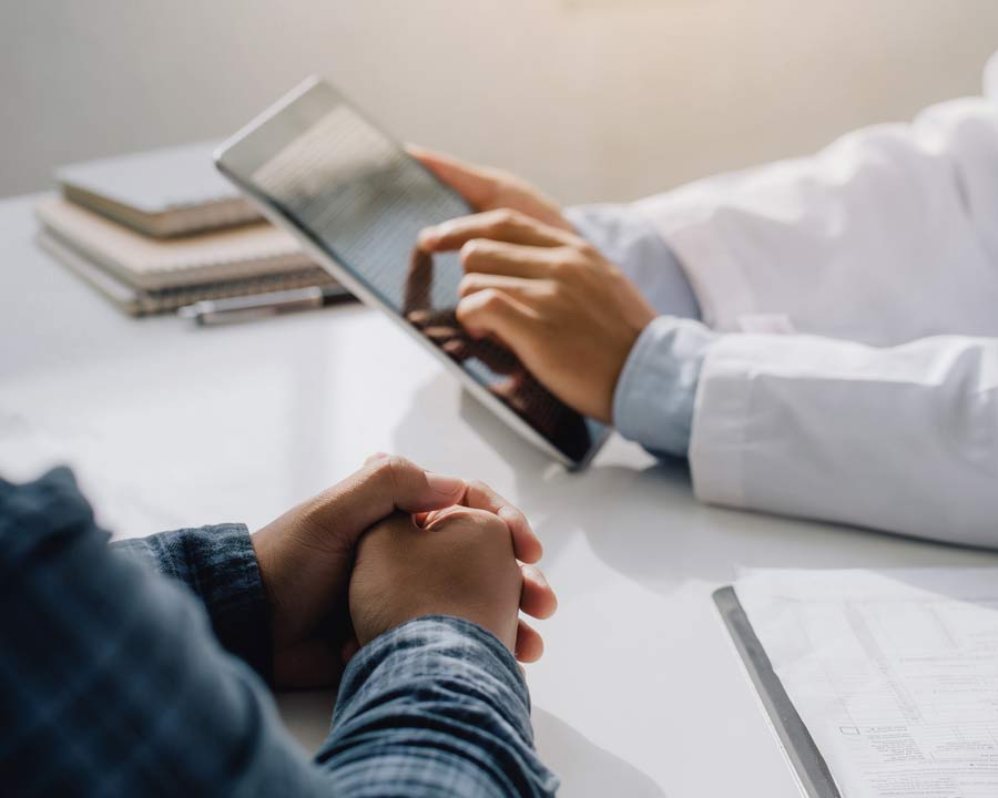 patient and doctor holding tablet