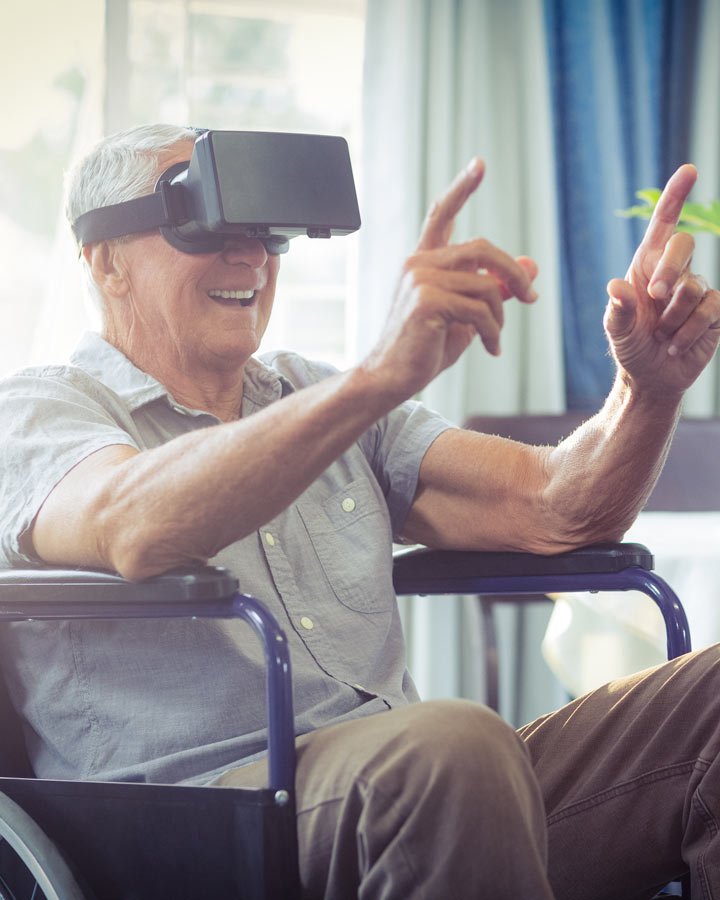 elderly man in wheelchair using virtual reality goggles