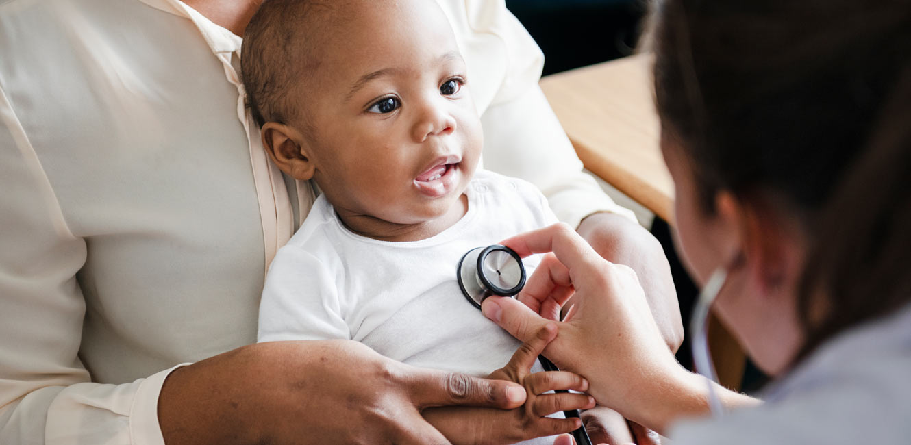 Doctor assessing baby with stethoscope