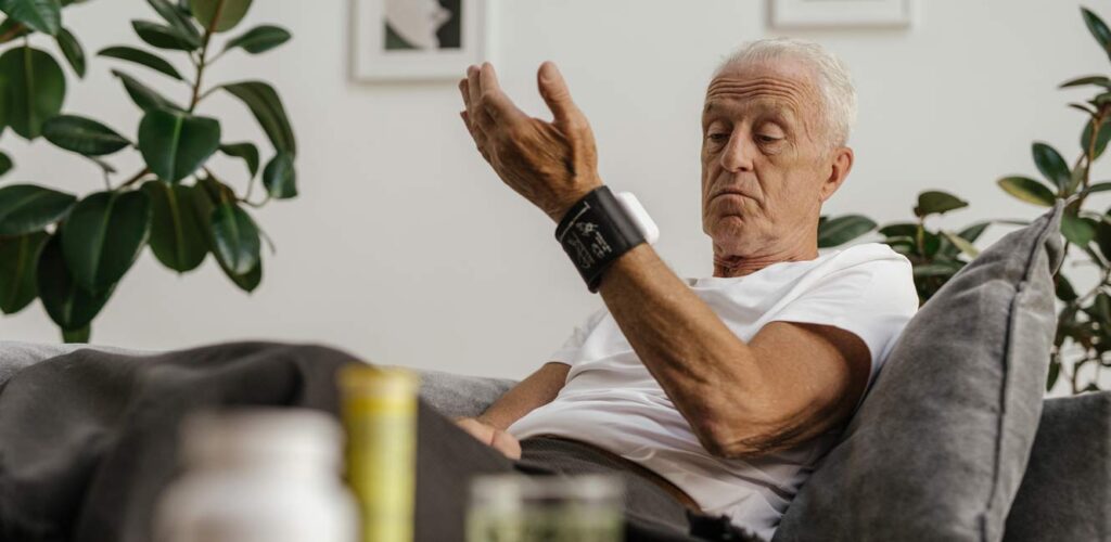 man using blood pressure cuff