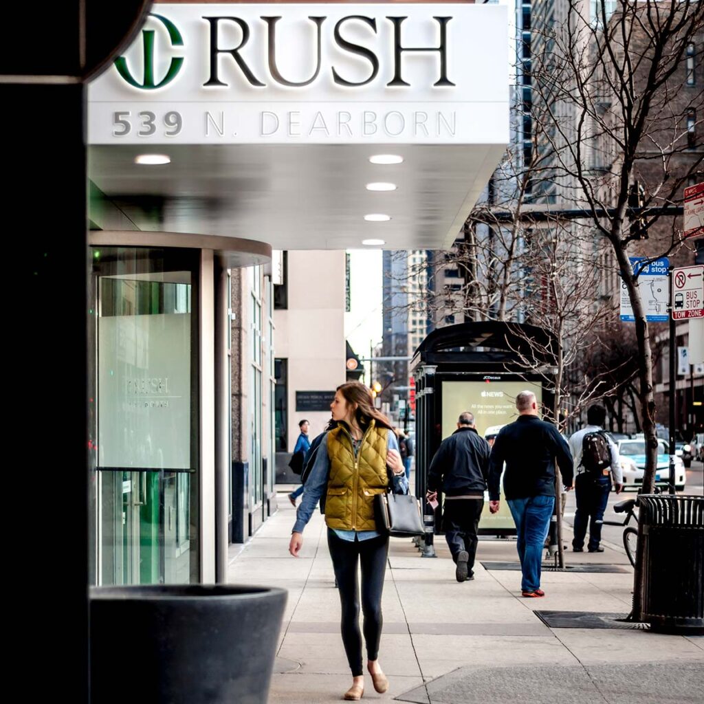 Woman Walking in front of a hospital